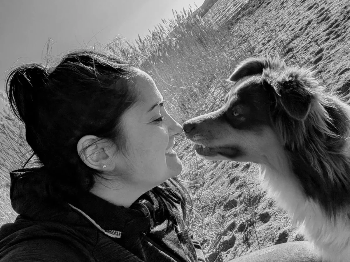 Julia Rastegar und ihr Hund begegnen einander aufmerksam und vertraut auf Augenhöhe.
